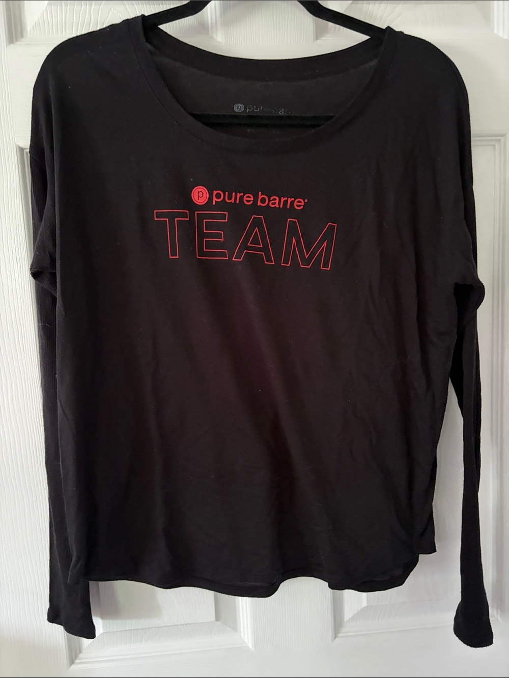 Pure Barre Long Sleeve Crewneck Top in Black with Red 'TEAM' Logo